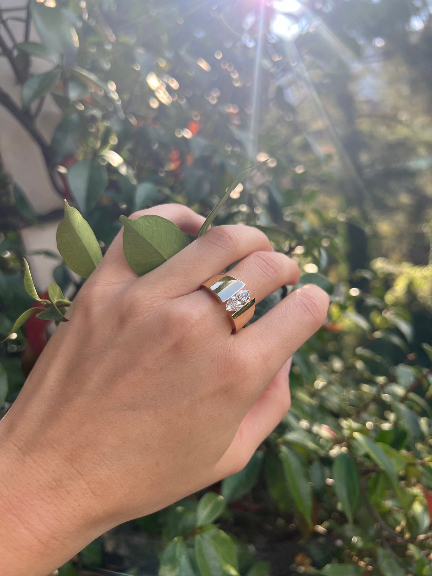 Luxurious floating marquise ring with a 1.5 lab crown diamond nestled in soft, creamy fabric, perfect for enhancing elegance.